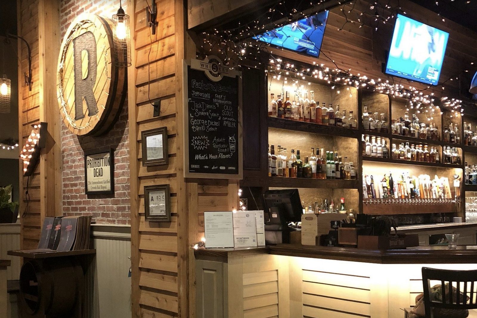 Backlit bourbon shelves and bar at The Rickhouse in Greenville
